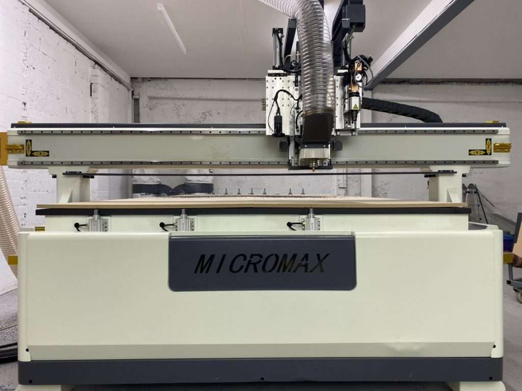 Micromax CNC router with vacuum table and dust extraction installed in UK manufacturing facility