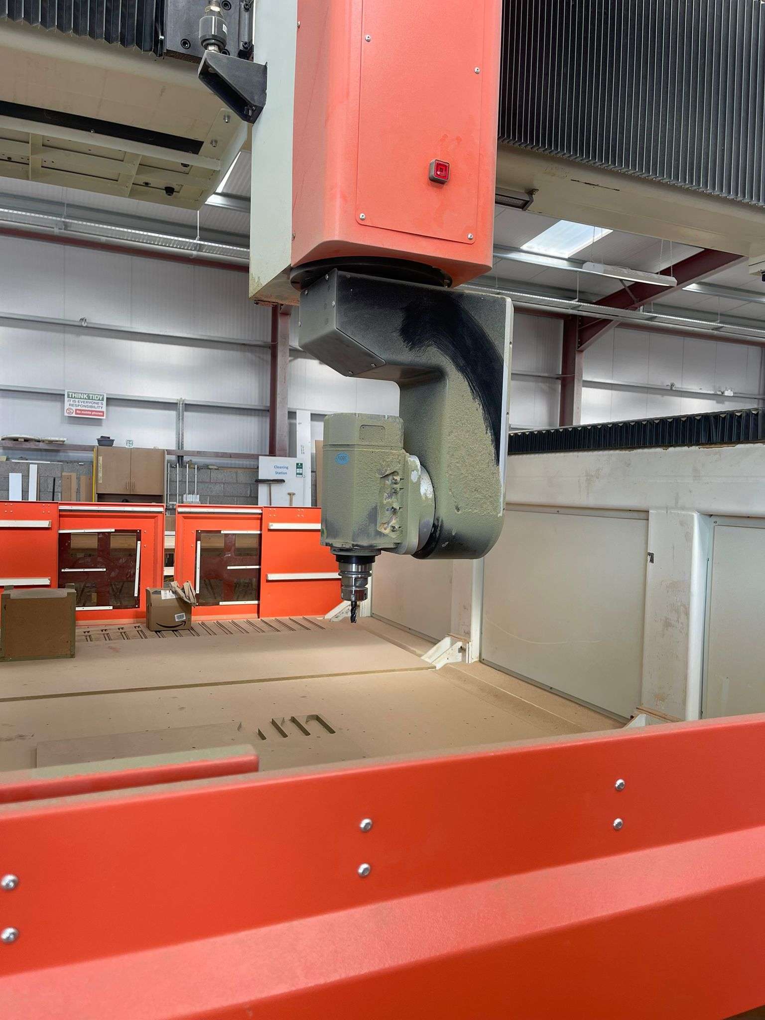 Close-up of CNC router spindle performing precision cutting in UK manufacturing facility